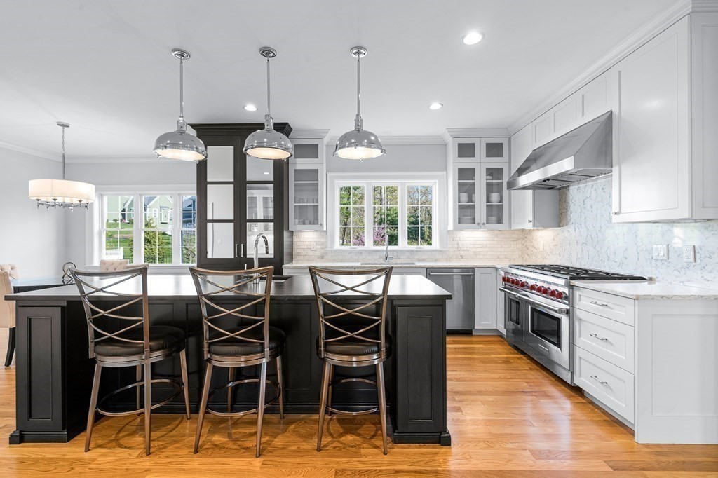 5 Cider Circle Bolton, MA 01740 - Photo 17 of 42 a kitchen with stainless steel appliances kitchen island granite countertop a table chairs sink and window