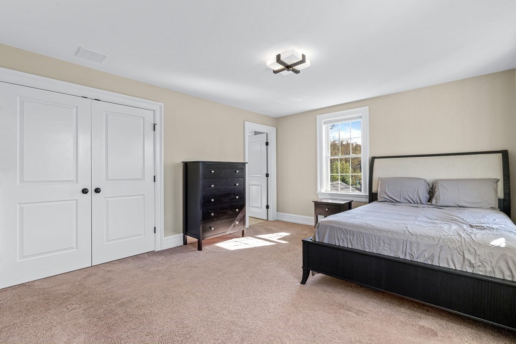 5 Cider Circle Bolton, MA 01740 - Photo 27 of 42 a spacious bedroom with a bed and a lamp on dresser