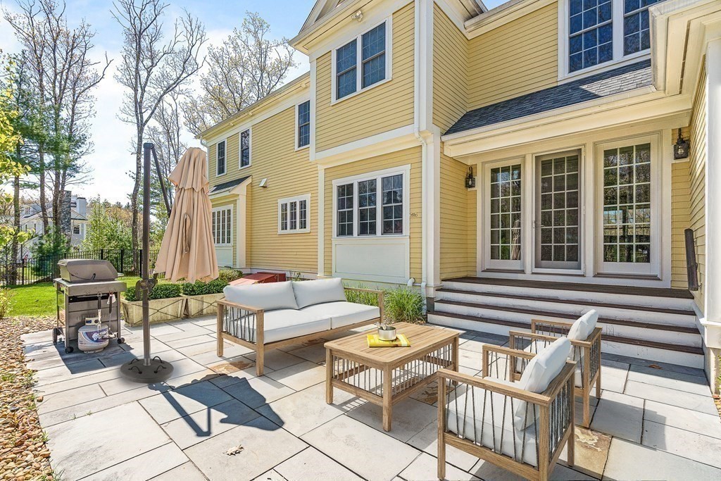 5 Cider Circle Bolton, MA 01740 - Photo 39 of 42 a view of a patio with couches table and chairs and wooden floor