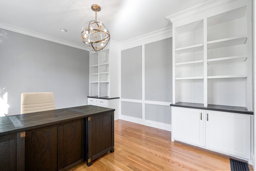 5 Cider Circle Bolton, MA 01740 - Photo 7 of 42 a kitchen with a wooden floor and cabinets