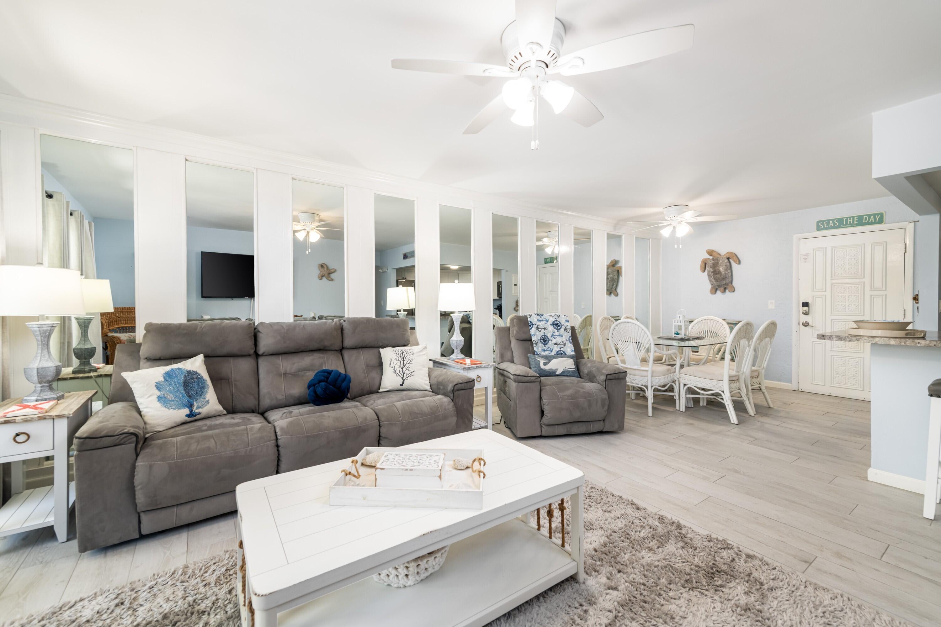 105 Ave D, Unit 101 Marathon, FL 33050 - Photo 11 of 32 a living room with furniture and a chandelier