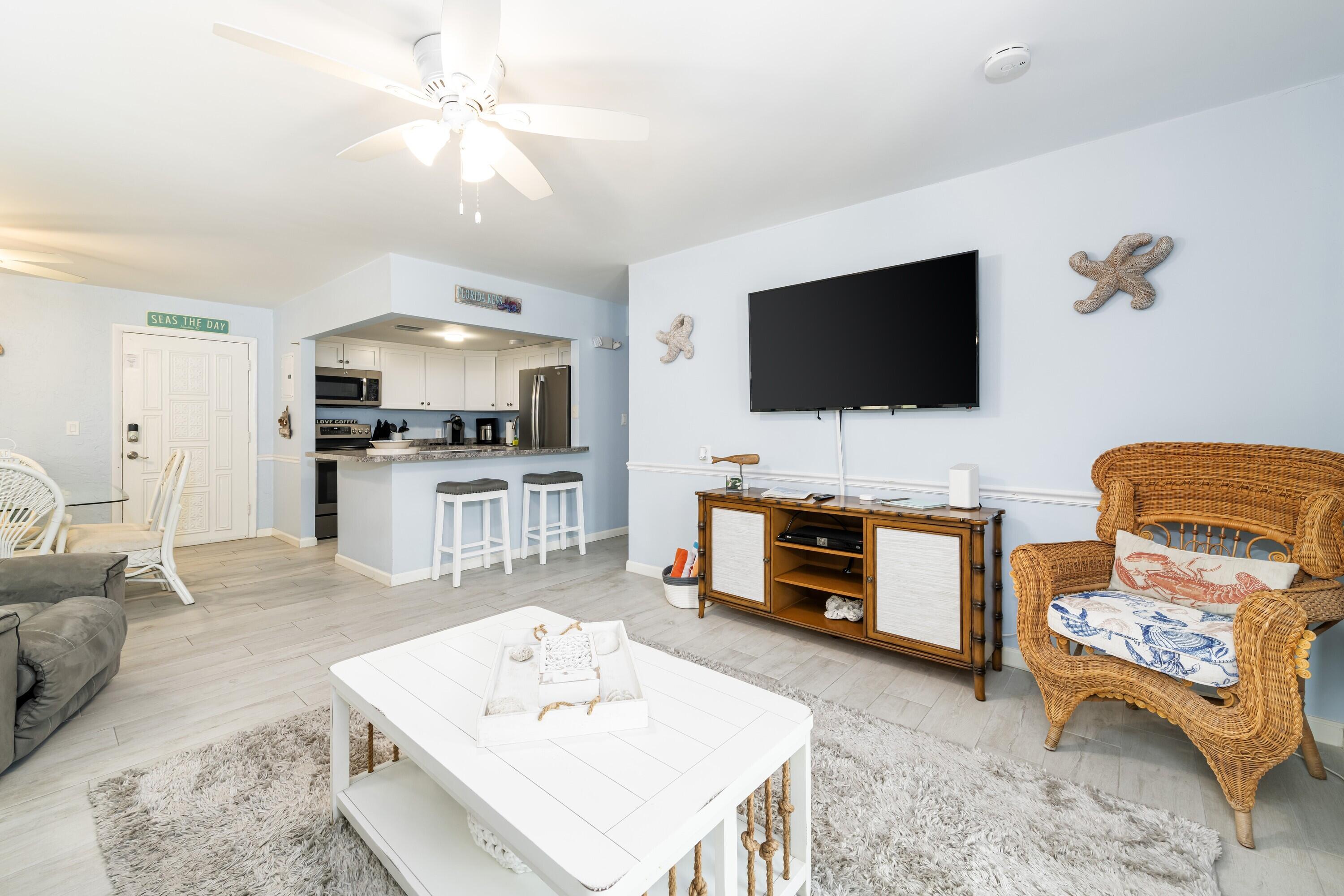 105 Ave D, Unit 101 Marathon, FL 33050 - Photo 12 of 32 a living room with furniture and a flat screen tv