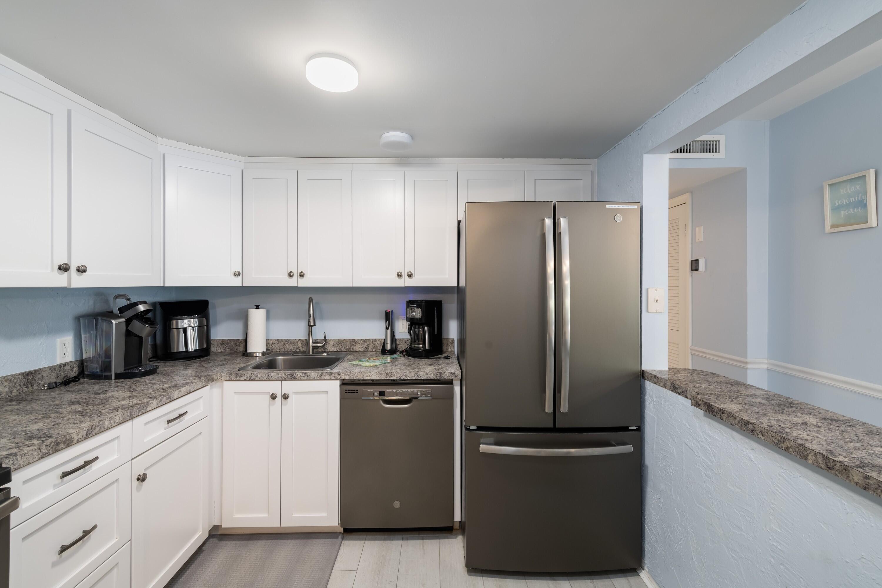 105 Ave D, Unit 101 Marathon, FL 33050 - Photo 14 of 32 a kitchen with granite countertop stainless steel appliances and refrigerator