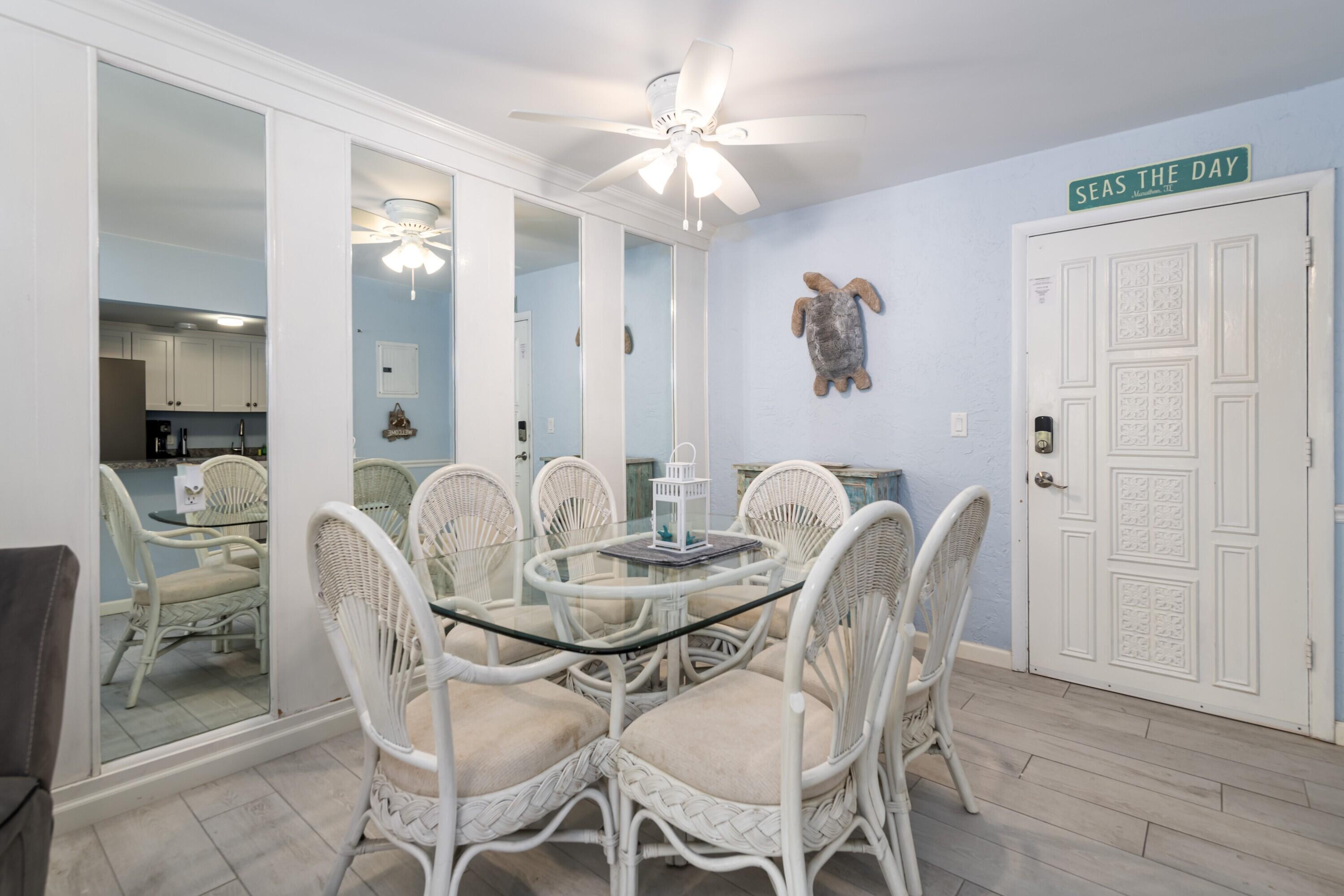 105 Ave D, Unit 101 Marathon, FL 33050 - Photo 15 of 32 a dining room with furniture and wooden floor