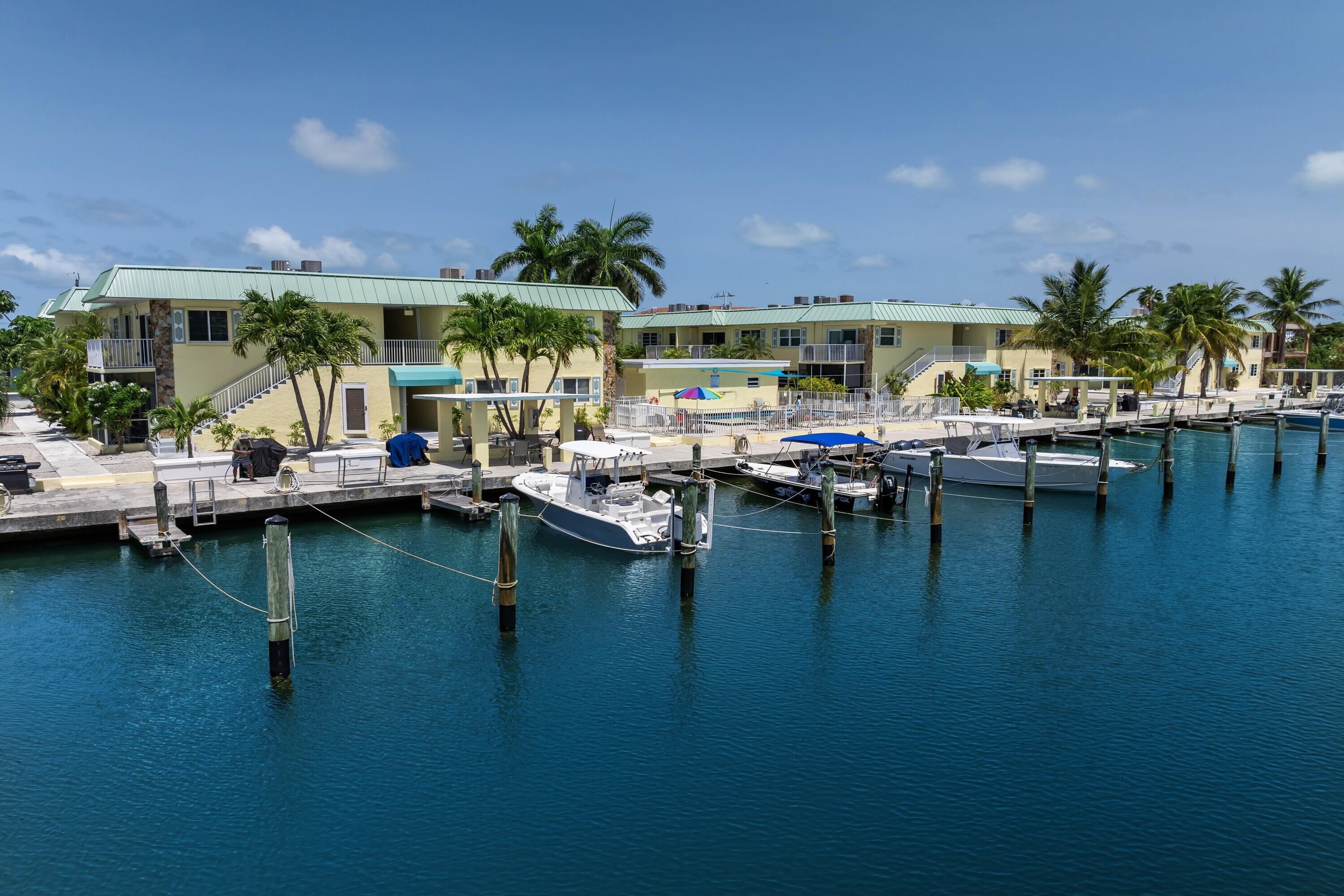 105 Ave D, Unit 101 Marathon, FL 33050 - Photo 2 of 32 a view of a swimming pool with outdoor seating