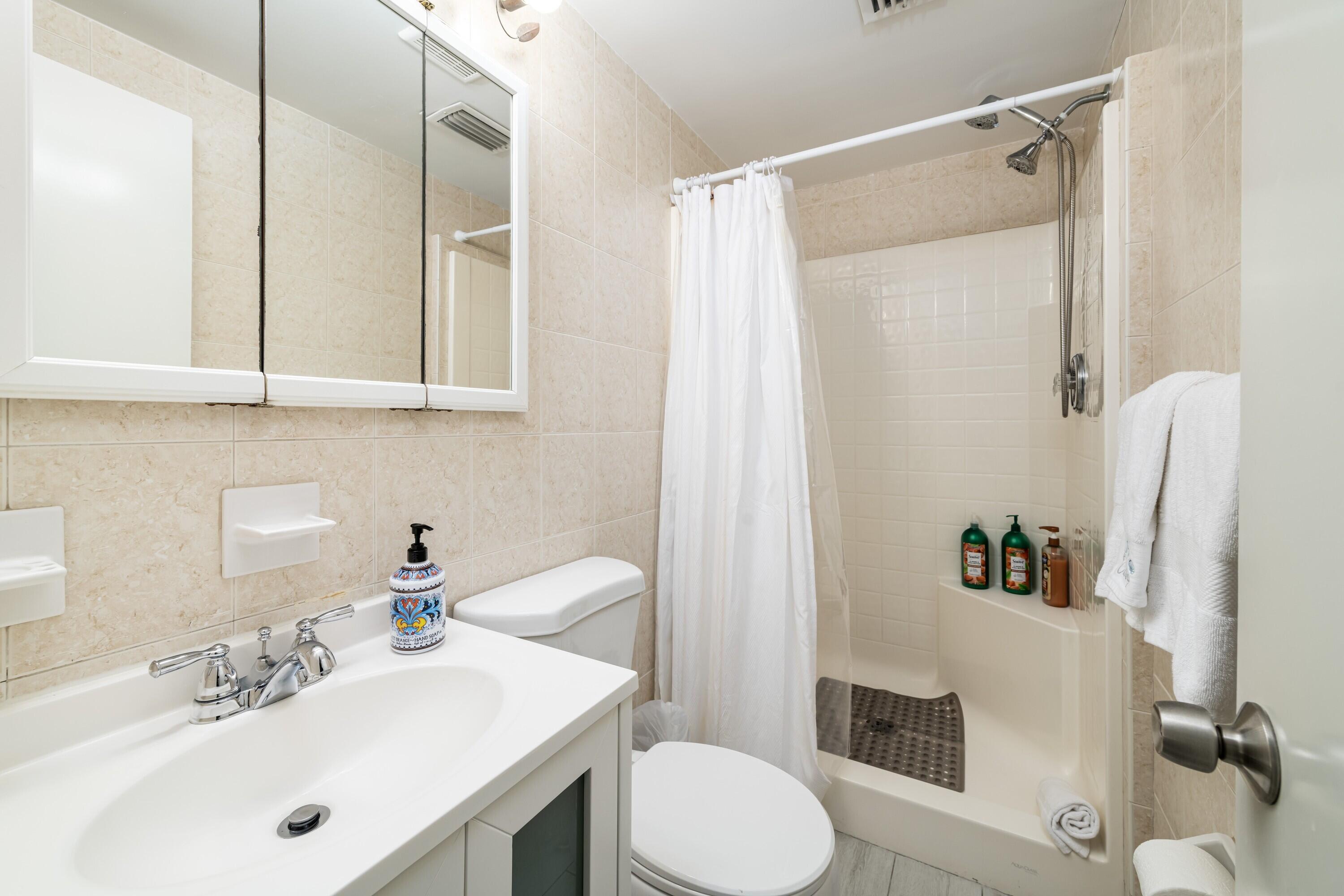 105 Ave D, Unit 101 Marathon, FL 33050 - Photo 22 of 32 a bathroom with a sink toilet and shower