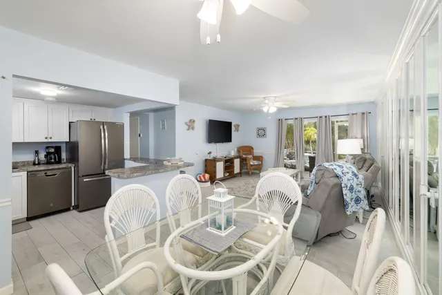 a living room with furniture a flat screen tv and a large window