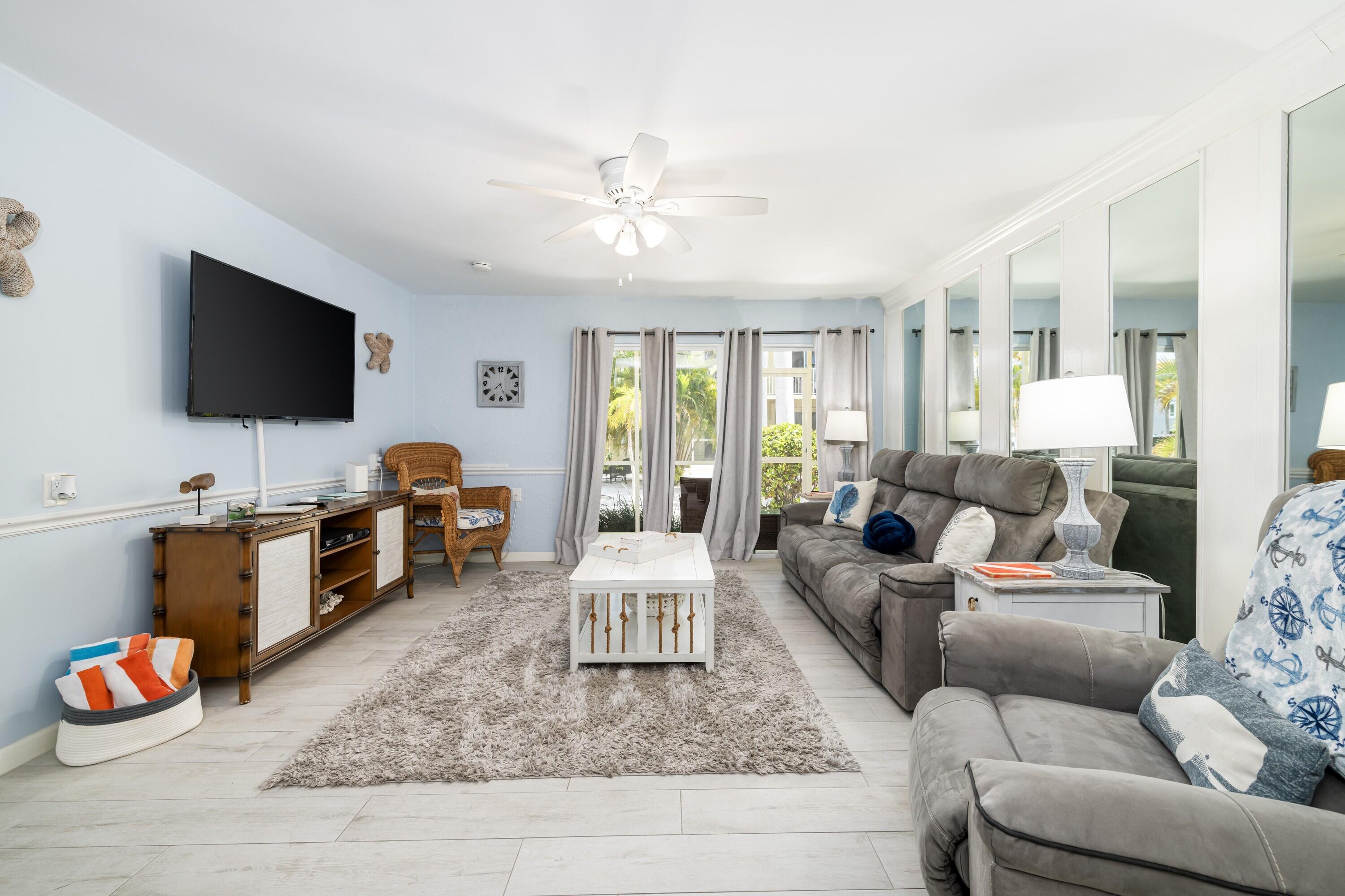 105 Ave D, Unit 101 Marathon, FL 33050 - Photo 6 of 32 a living room with furniture and a flat screen tv