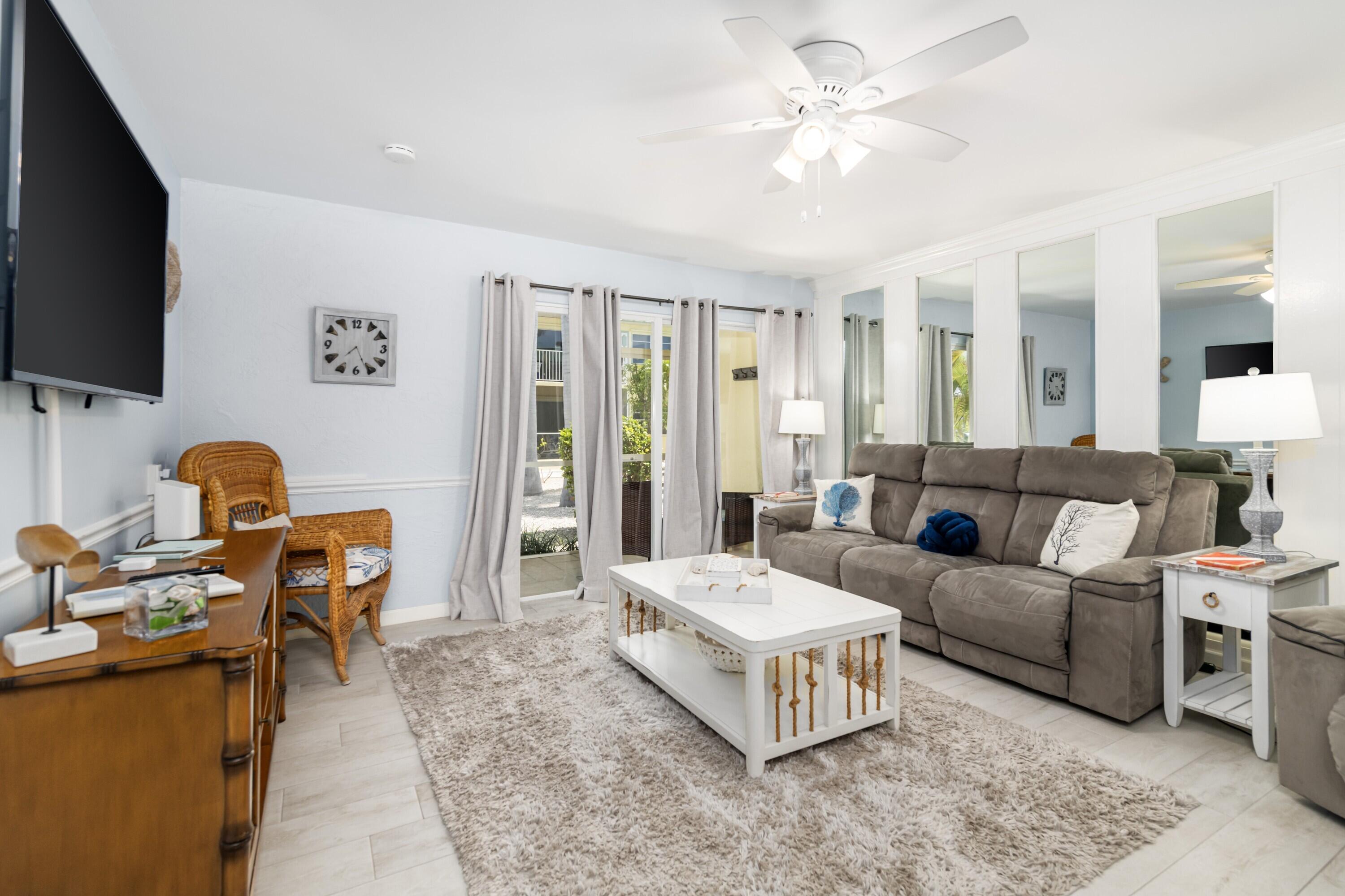 105 Ave D, Unit 101 Marathon, FL 33050 - Photo 10 of 32 a living room with furniture and a flat screen tv