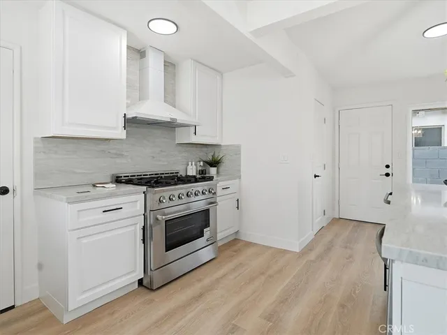a spacious bedroom with two beds and a potted plant