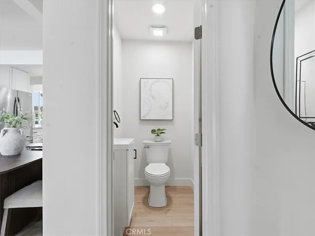a white toilet sitting next to a bathroom sink