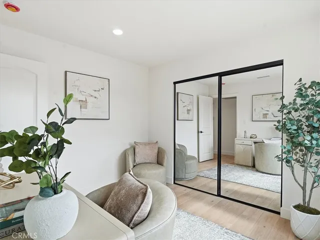 a bedroom with a bed and a painting on the wall