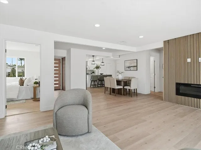 a spacious bedroom with a bed and a painting on the wall