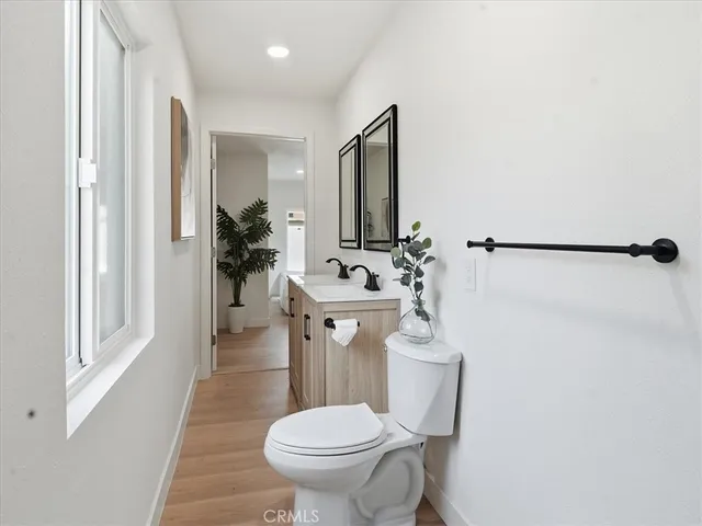 a bedroom with a large bed and a potted plant