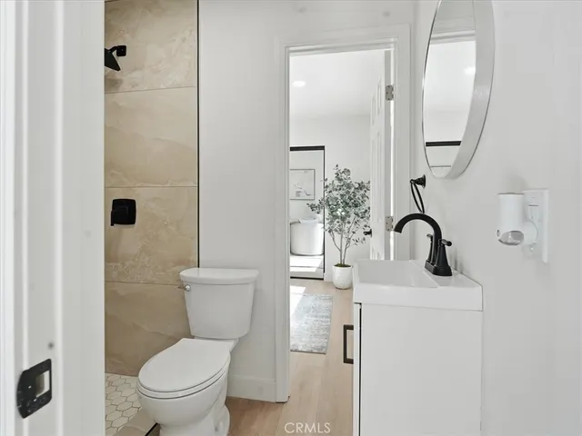 a bathroom with a toilet sink and mirror