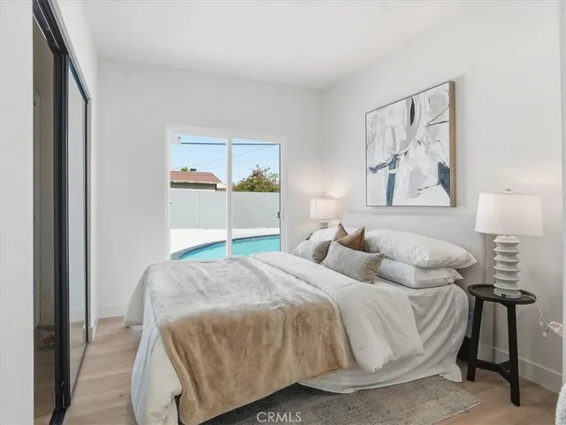 a living room with a sink and a refrigerator