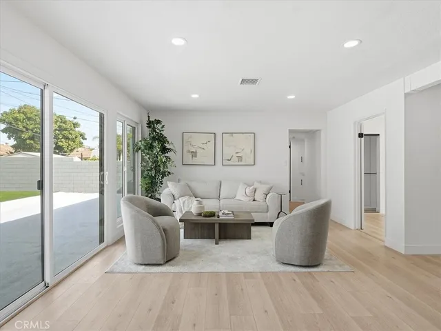 a living room with furniture and large windows