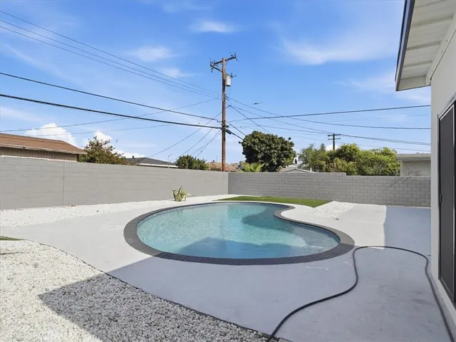 a view of a swimming pool with a yard