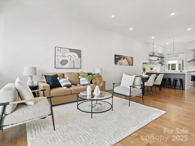 a living room with furniture a rug and a table