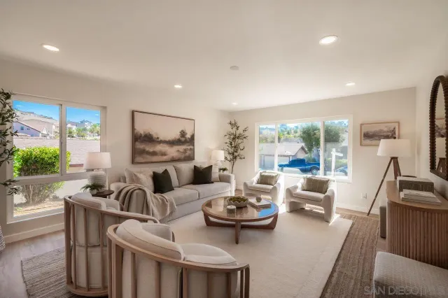 a kitchen with stainless steel appliances a sink a stove a table and chairs