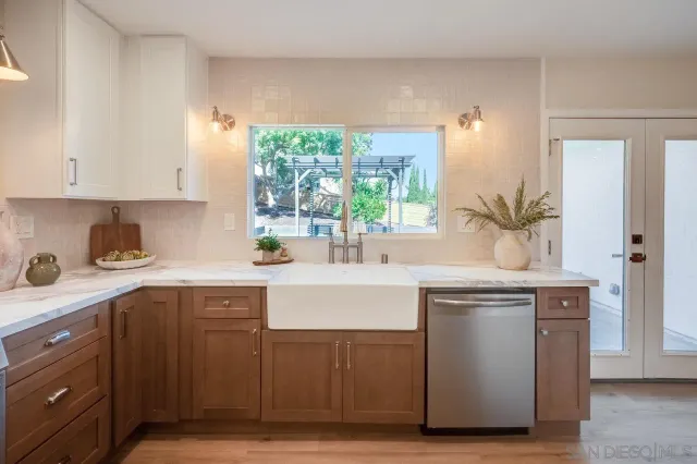 a kitchen with cabinets a sink and stainless steel appliances