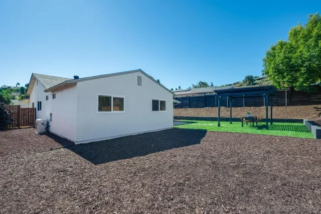 a kitchen with kitchen island a counter top space a sink stainless steel appliances and cabinets
