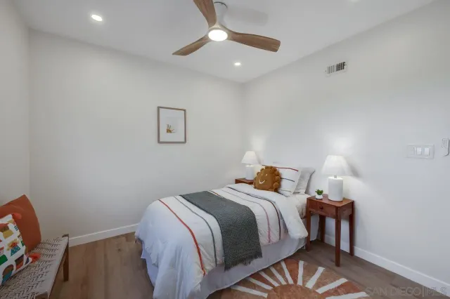 a bedroom with a large bed and a chandelier