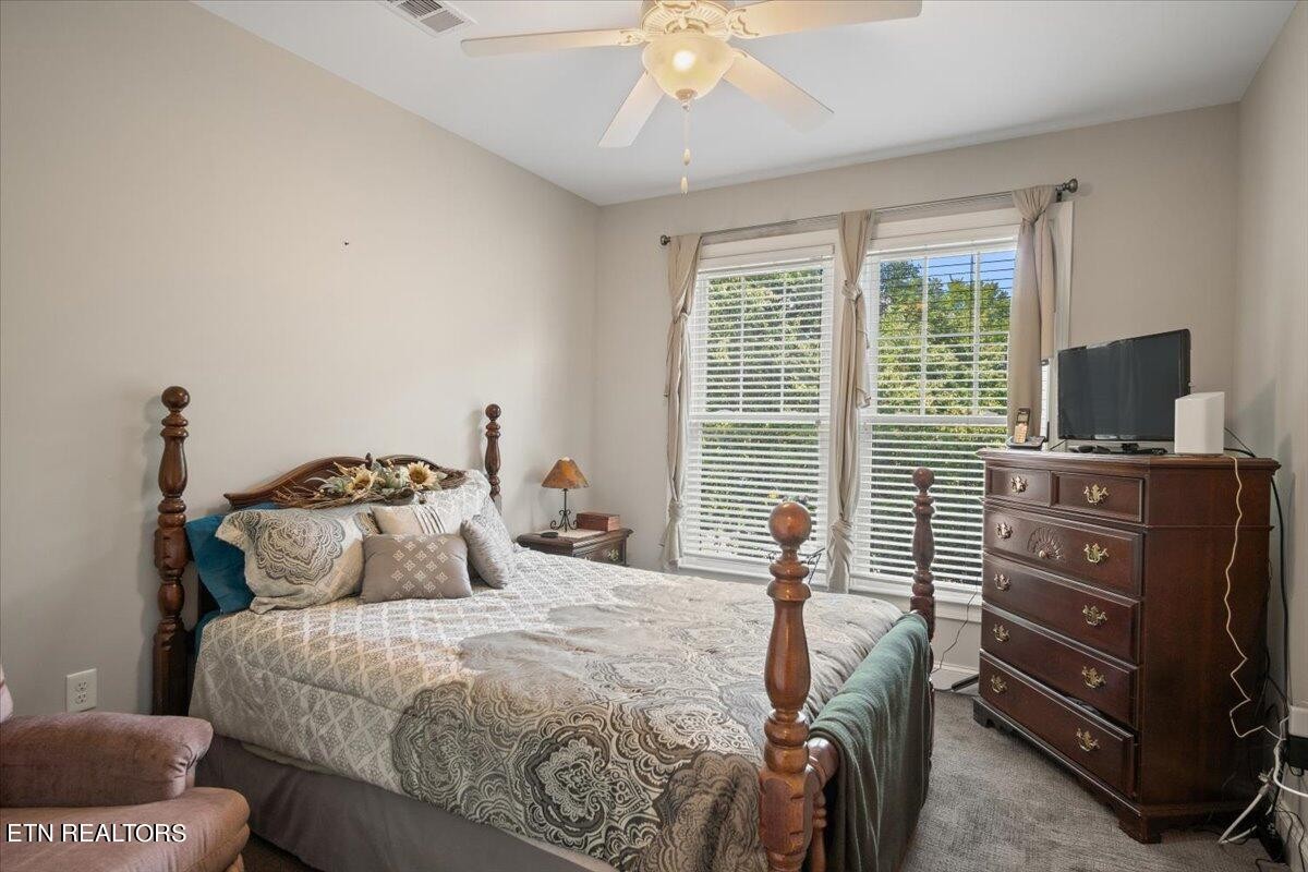 315 Centennial Bluff Boulevard Oak Ridge, TN 37830 - Photo 18 of 24 a bedroom with a bed and a flat tv screen