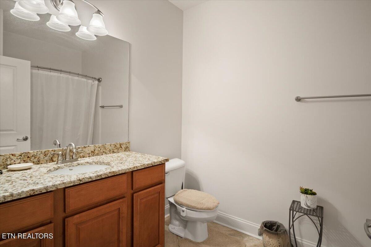 315 Centennial Bluff Boulevard Oak Ridge, TN 37830 - Photo 19 of 24 a bathroom with a granite countertop sink vanity mirror and toilet