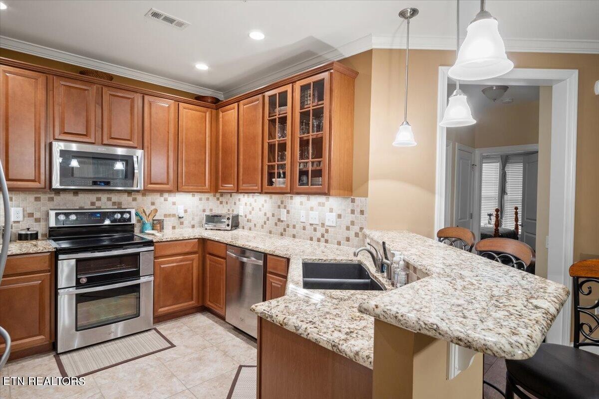 315 Centennial Bluff Boulevard Oak Ridge, TN 37830 - Photo 9 of 24 a kitchen with stainless steel appliances granite countertop a sink stove and refrigerator