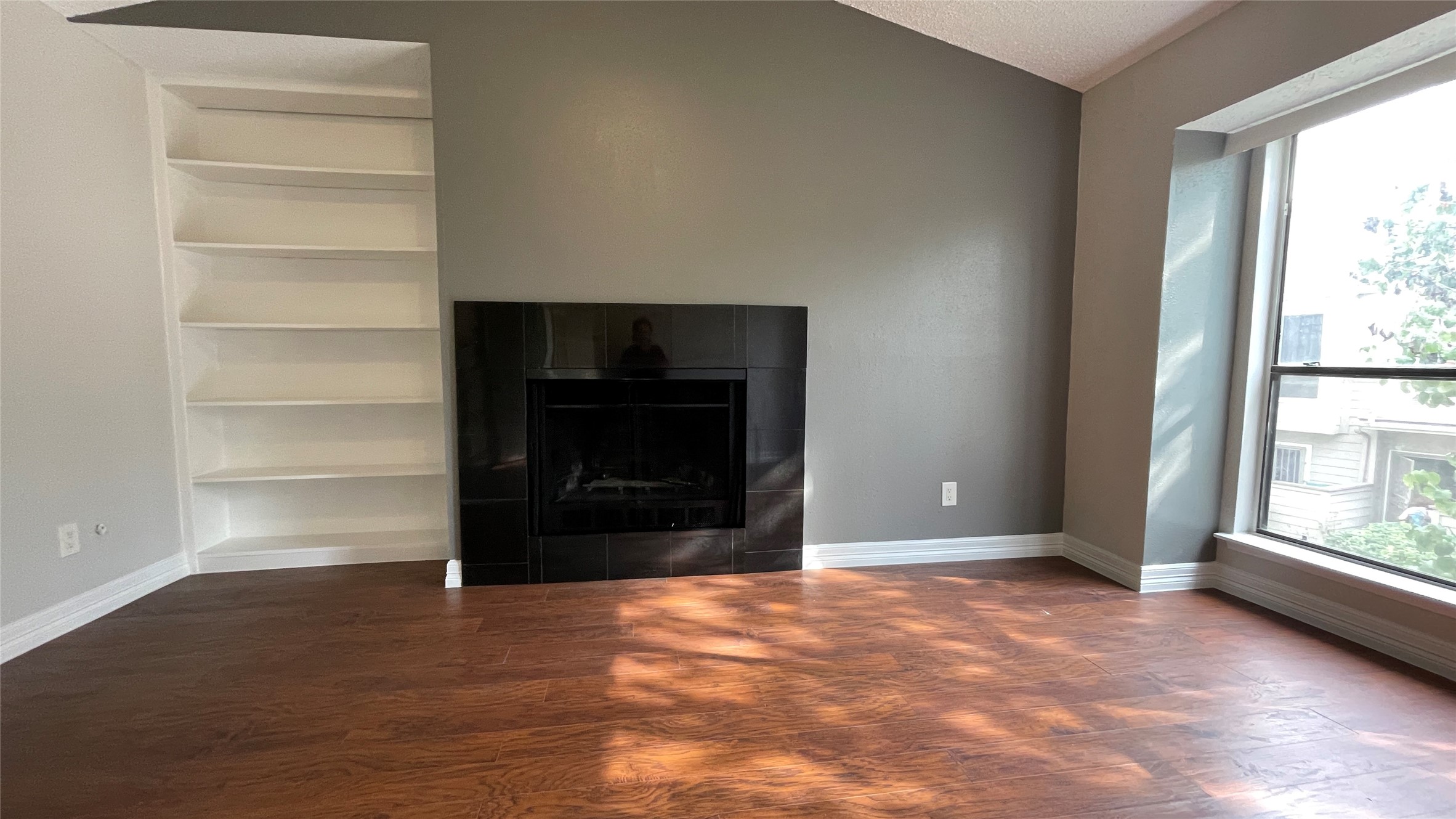 6701 Sands Point Drive, Unit 33 Houston, TX 77074 - Photo 3 of 17 a view of an empty room with a window and fire place