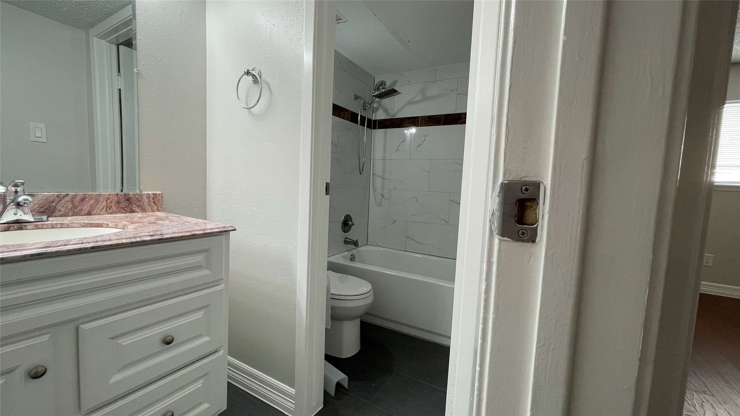 6701 Sands Point Drive, Unit 33 Houston, TX 77074 - Photo 7 of 17 a bathroom with a granite countertop sink a toilet and shower