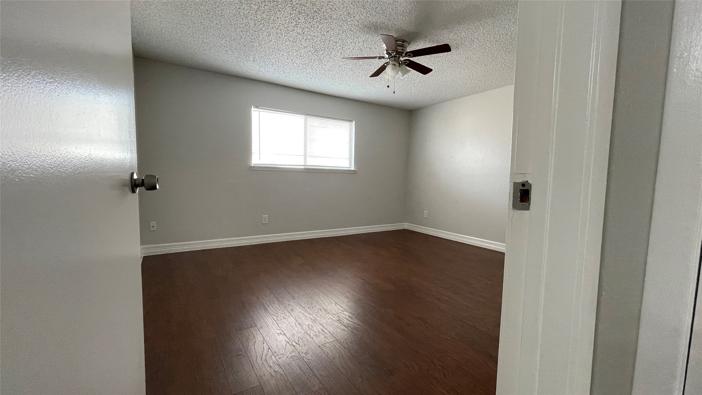 6701 Sands Point Drive, Unit 33 Houston, TX 77074 - Photo 8 of 17 a view of empty room with wooden floor and fan