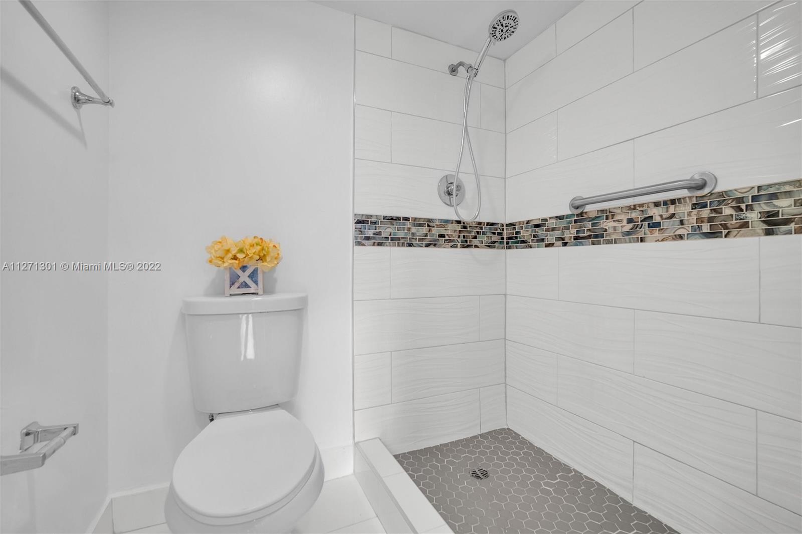 300 Southwest 130th Terrace, Unit 106B Pembroke Pines, FL 33027 - Photo 17 of 43 a bathroom with a toilet a sink and shower