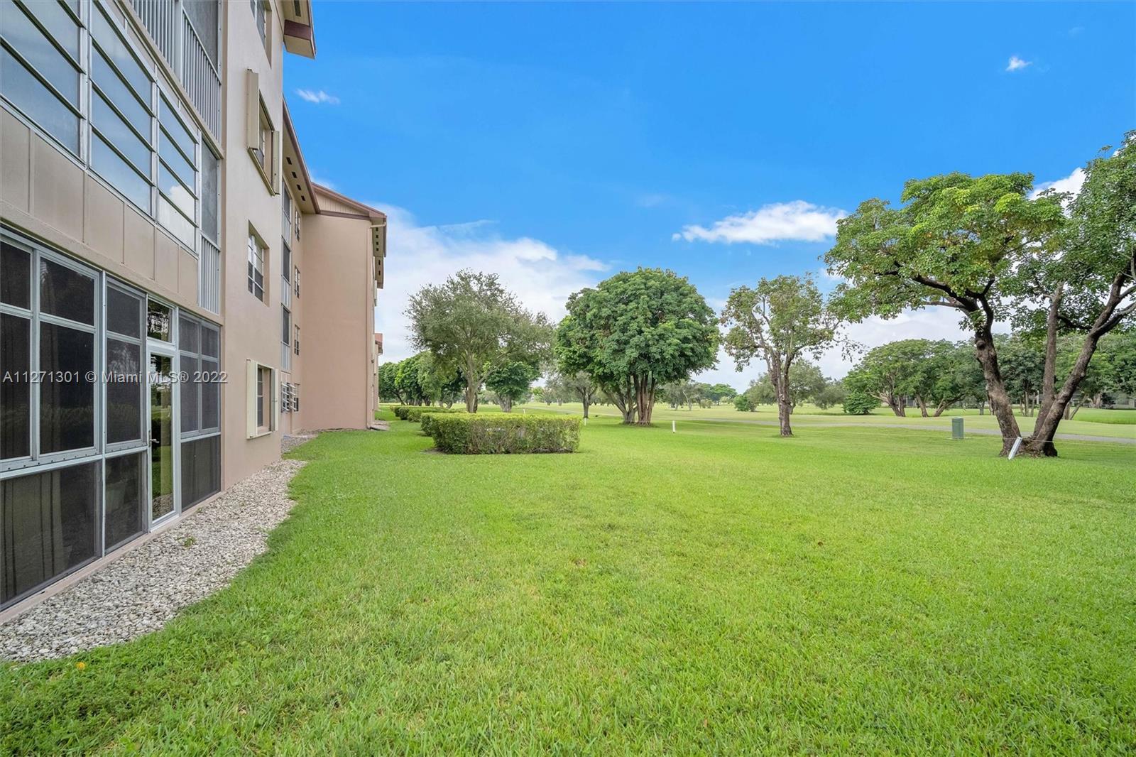 300 Southwest 130th Terrace, Unit 106B Pembroke Pines, FL 33027 - Photo 24 of 43 a view of an house with backyard space and garden