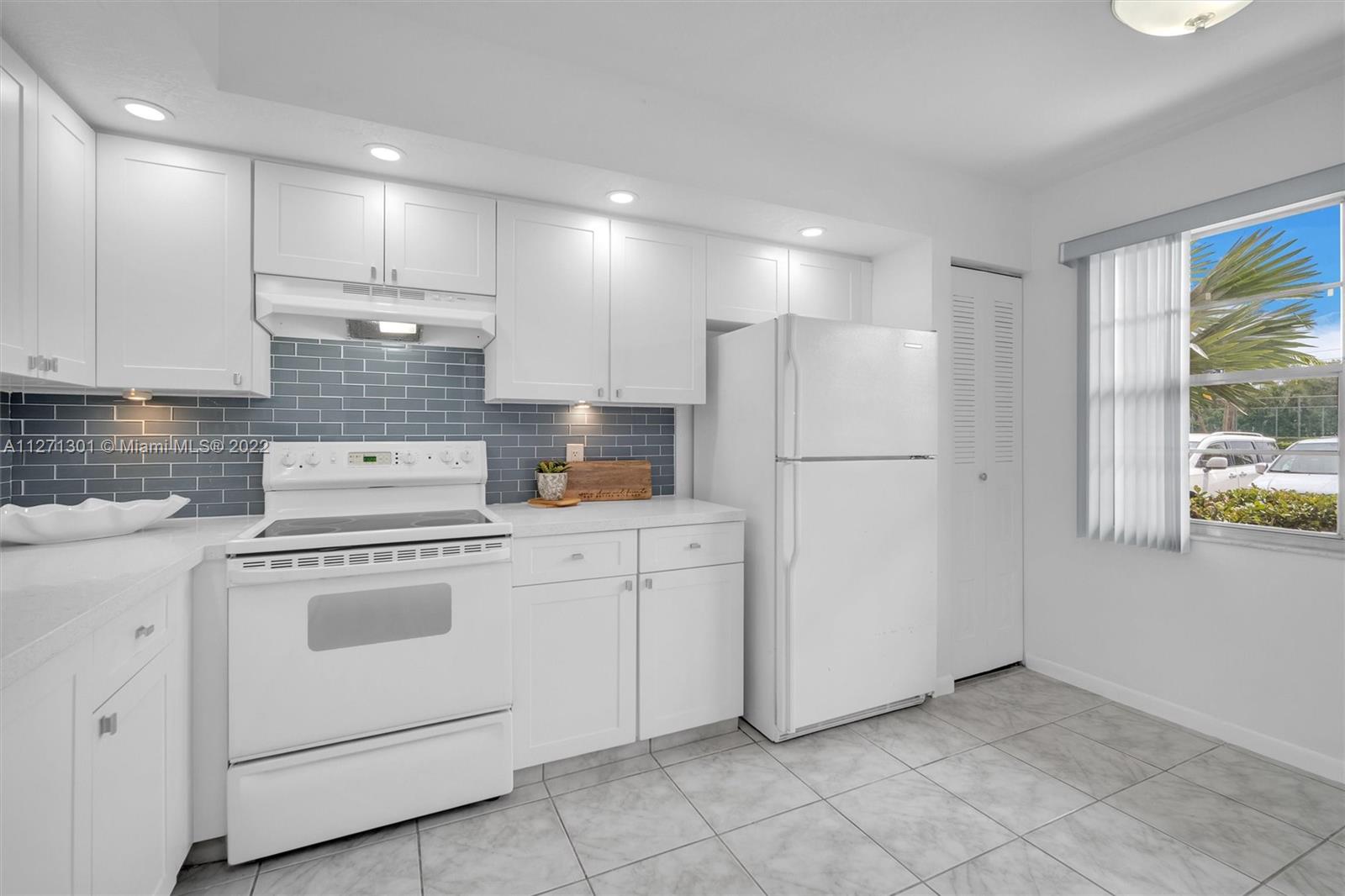 300 Southwest 130th Terrace, Unit 106B Pembroke Pines, FL 33027 - Photo 5 of 43 a kitchen with cabinets and stainless steel appliances