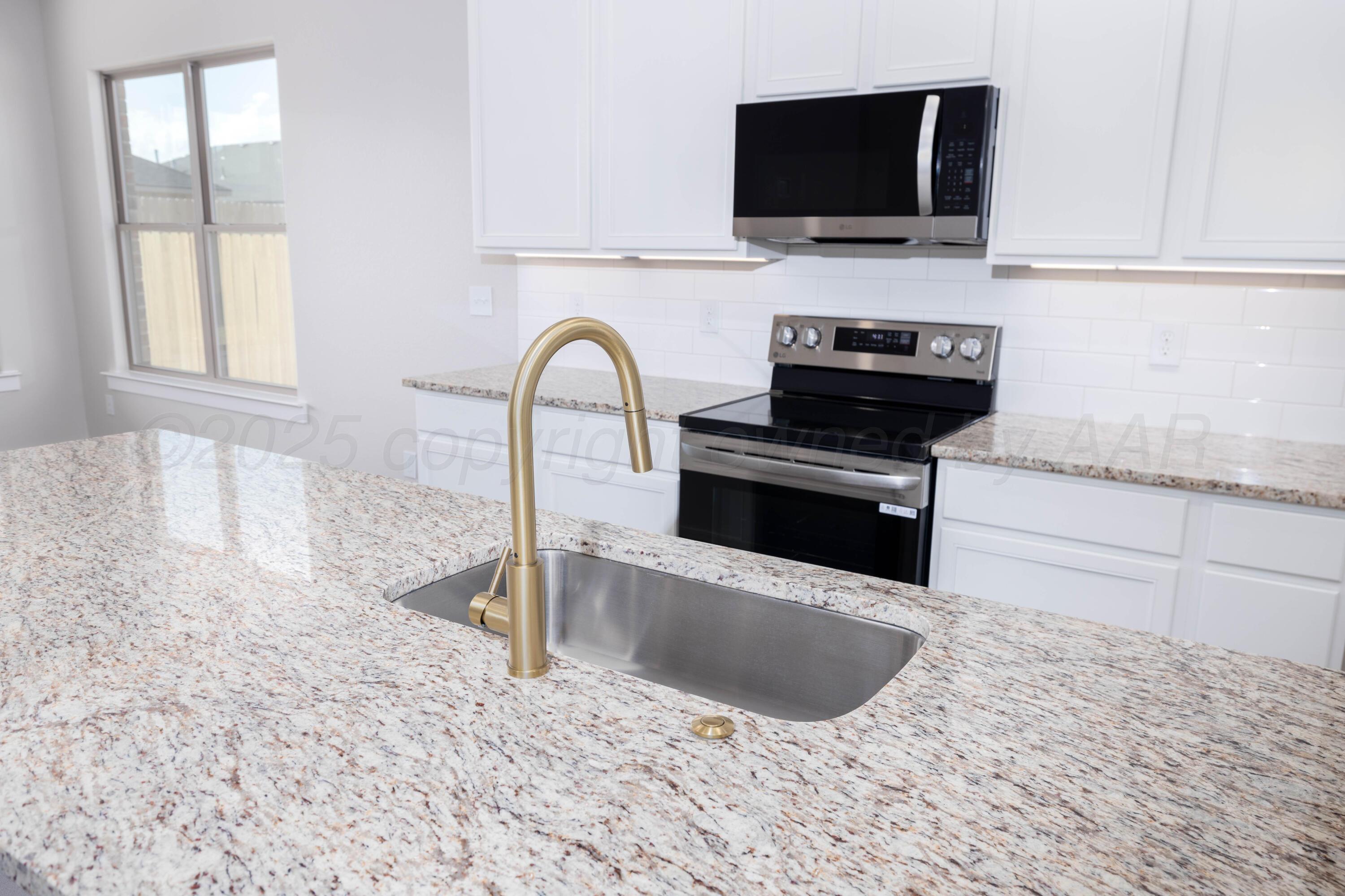 3012 Buckthorn Drive Amarillo, TX 79124 - Photo 2 of 9 a kitchen with granite countertop a sink and a stove top oven
