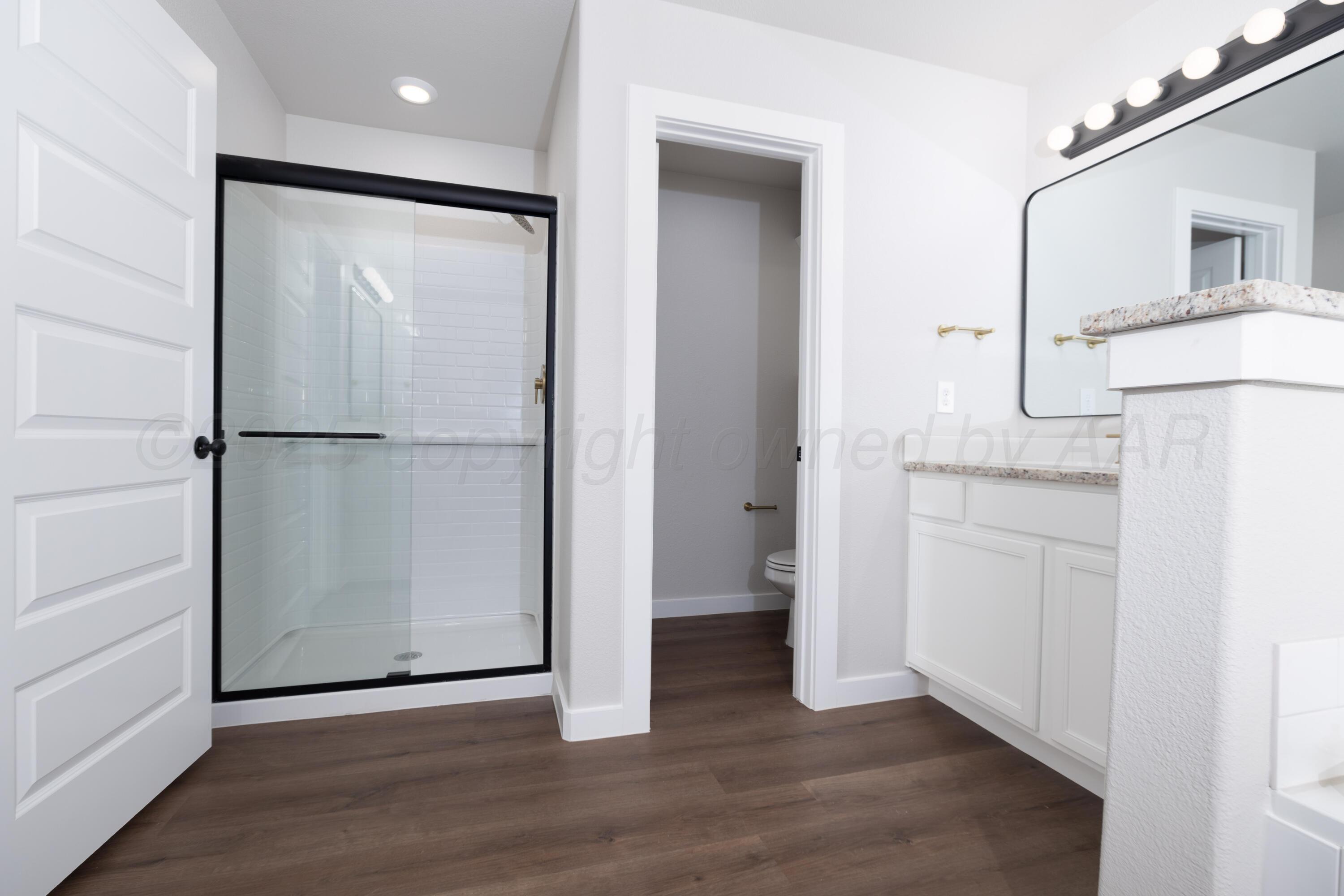 3012 Buckthorn Drive Amarillo, TX 79124 - Photo 7 of 9 a view of a hallway with wooden floor and cabinet
