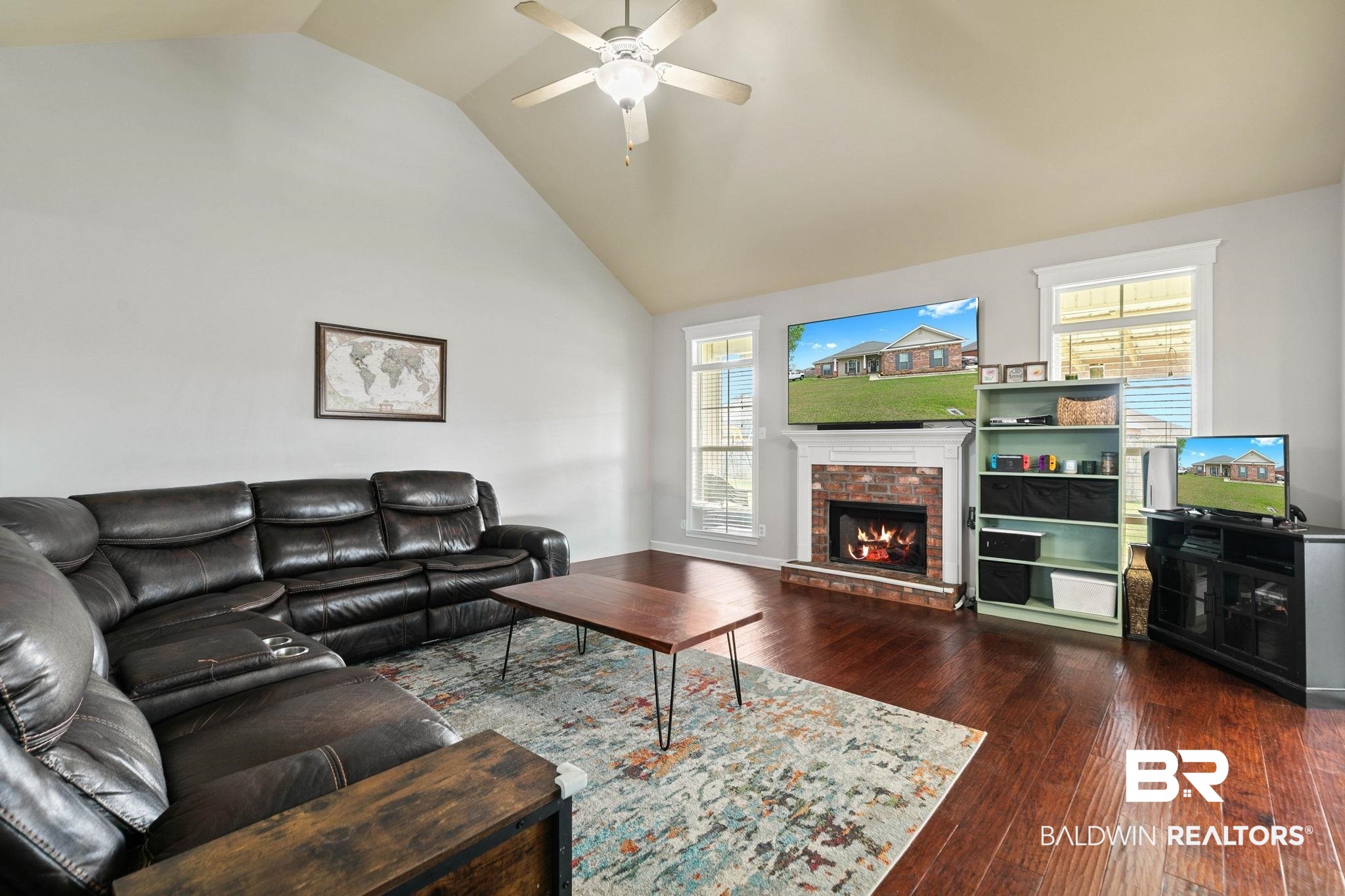 9177 Labrador Trail Theodore, AL 36582 - Photo 5 of 24 Living room featuring dark wood-style floors, vaulted ceiling, a fireplace, and ceiling fan