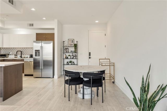 a kitchen with stainless steel appliances a refrigerator and a stove