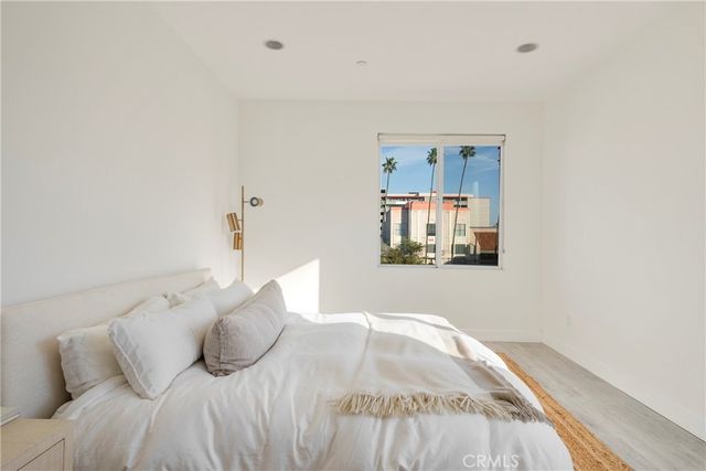 a bedroom with a bed and glass wall