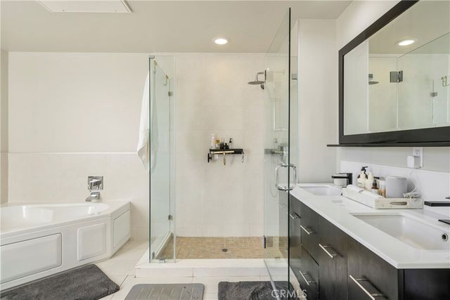 a bathroom with a double vanity sink mirror double and shower