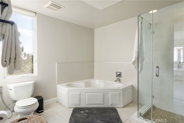 a bathroom with a white toilet sitting next to a bathroom sink