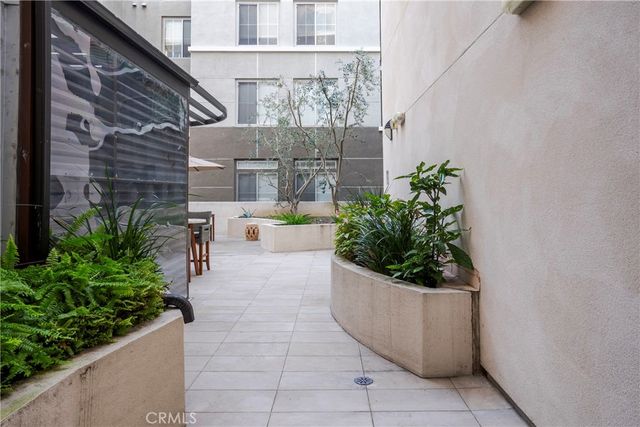 a view of a patio with plants and flowers