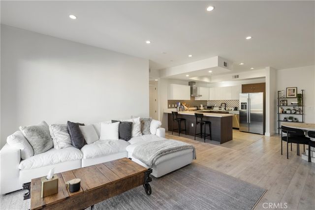 a living room with furniture and kitchen view