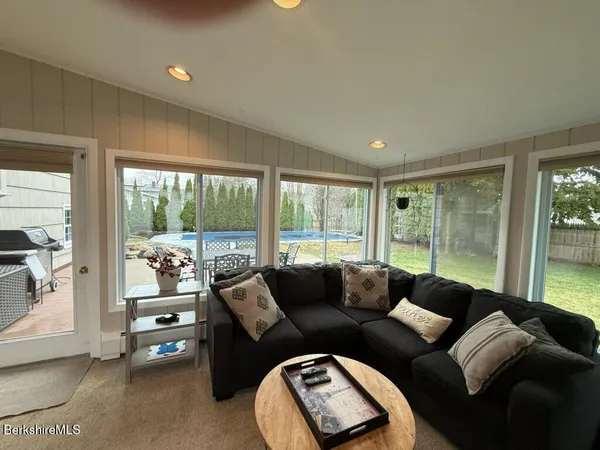 a living room with furniture and a floor to ceiling window