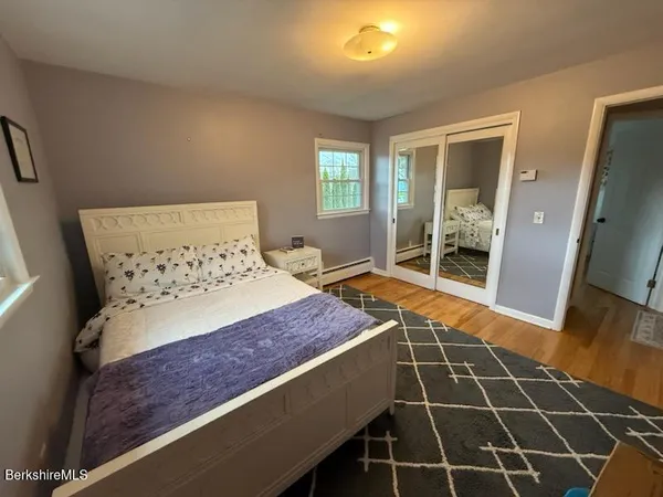 a bedroom with a bed and a desk in it