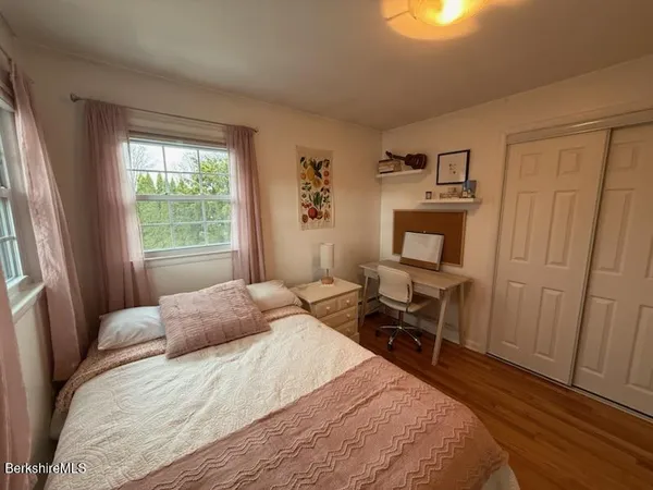 a bedroom with a large bed and a window