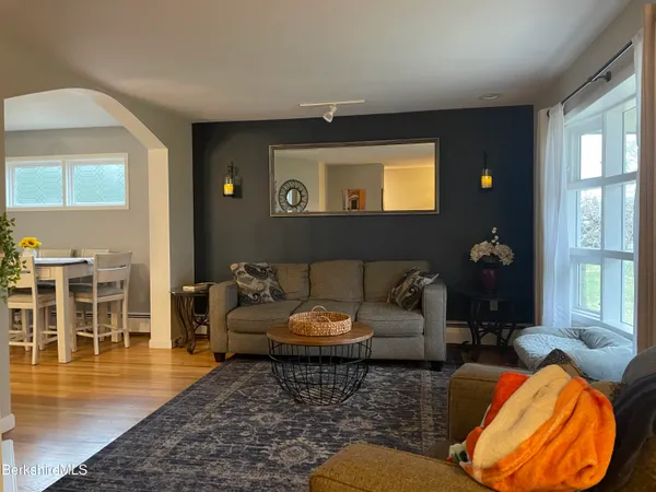 a living room with furniture and wooden floor