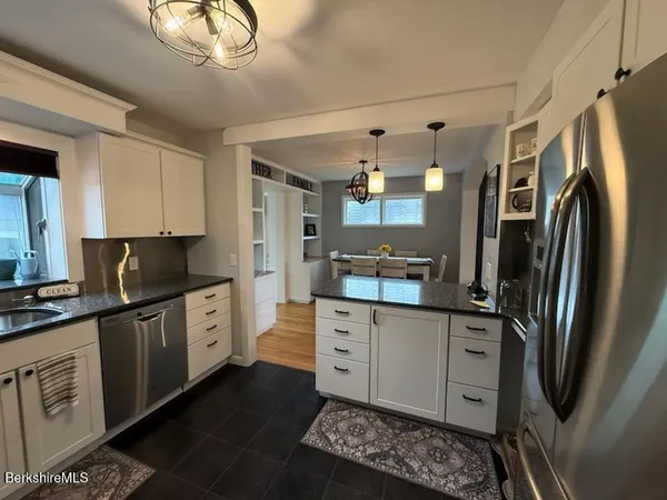 a kitchen with stainless steel appliances a refrigerator sink and cabinets